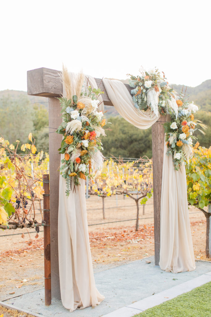 fall wedding - wooden ceremony arch with draping and flowers - MO|HI Sycamore Creek Vineyards - Angela Sue Photography