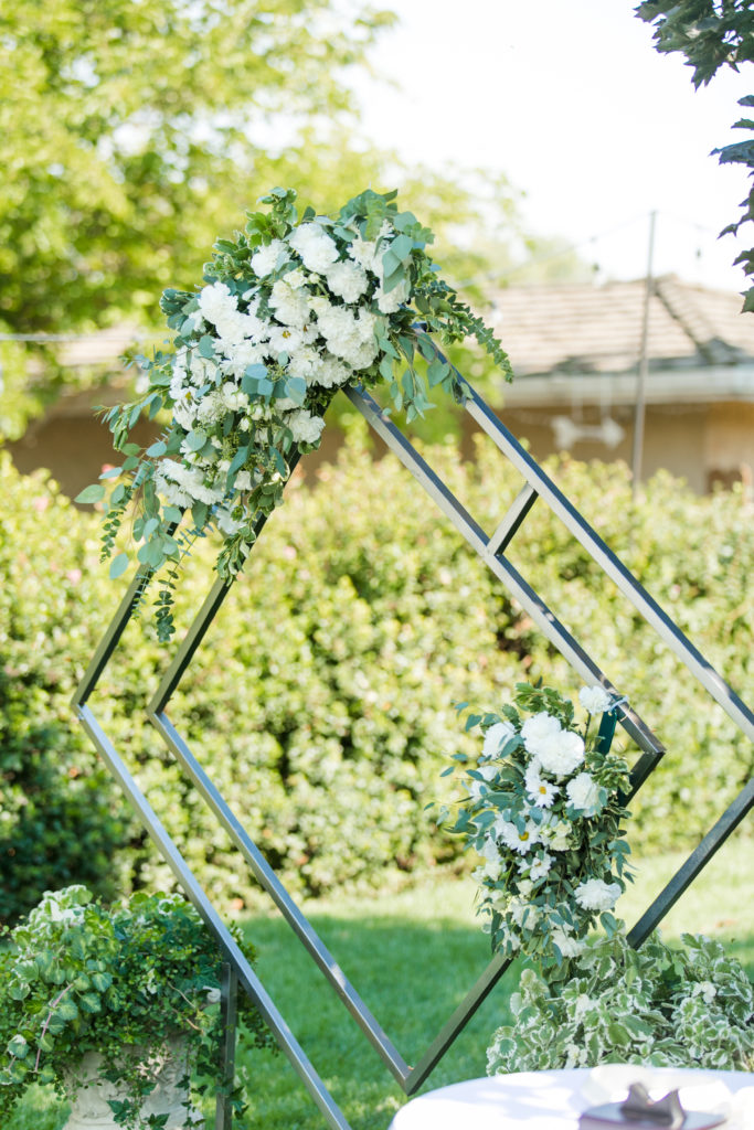 unique ceremony arch with flower sprays - backyard weddings - Angela Sue Photography