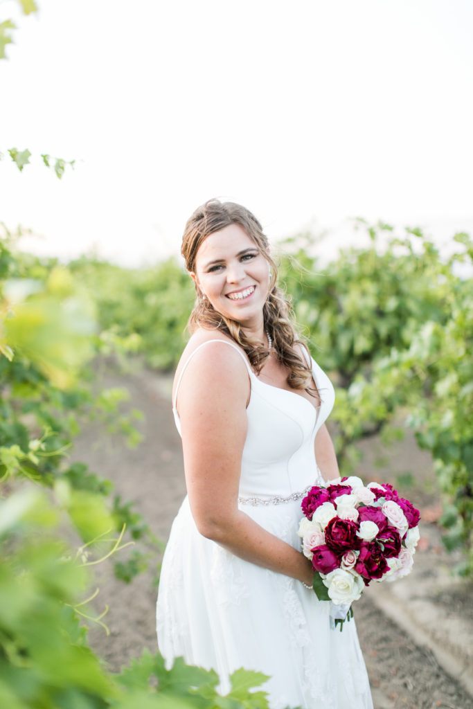 bride smiling at camera - wedding photo inspiration - vineyard wedding - Angela Sue Photography
