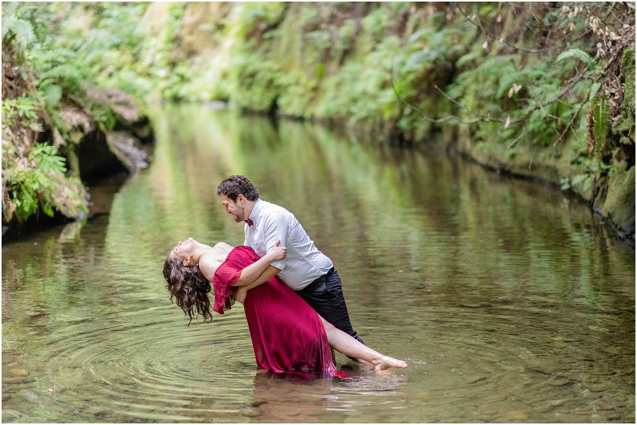 engaged couple dips in the river