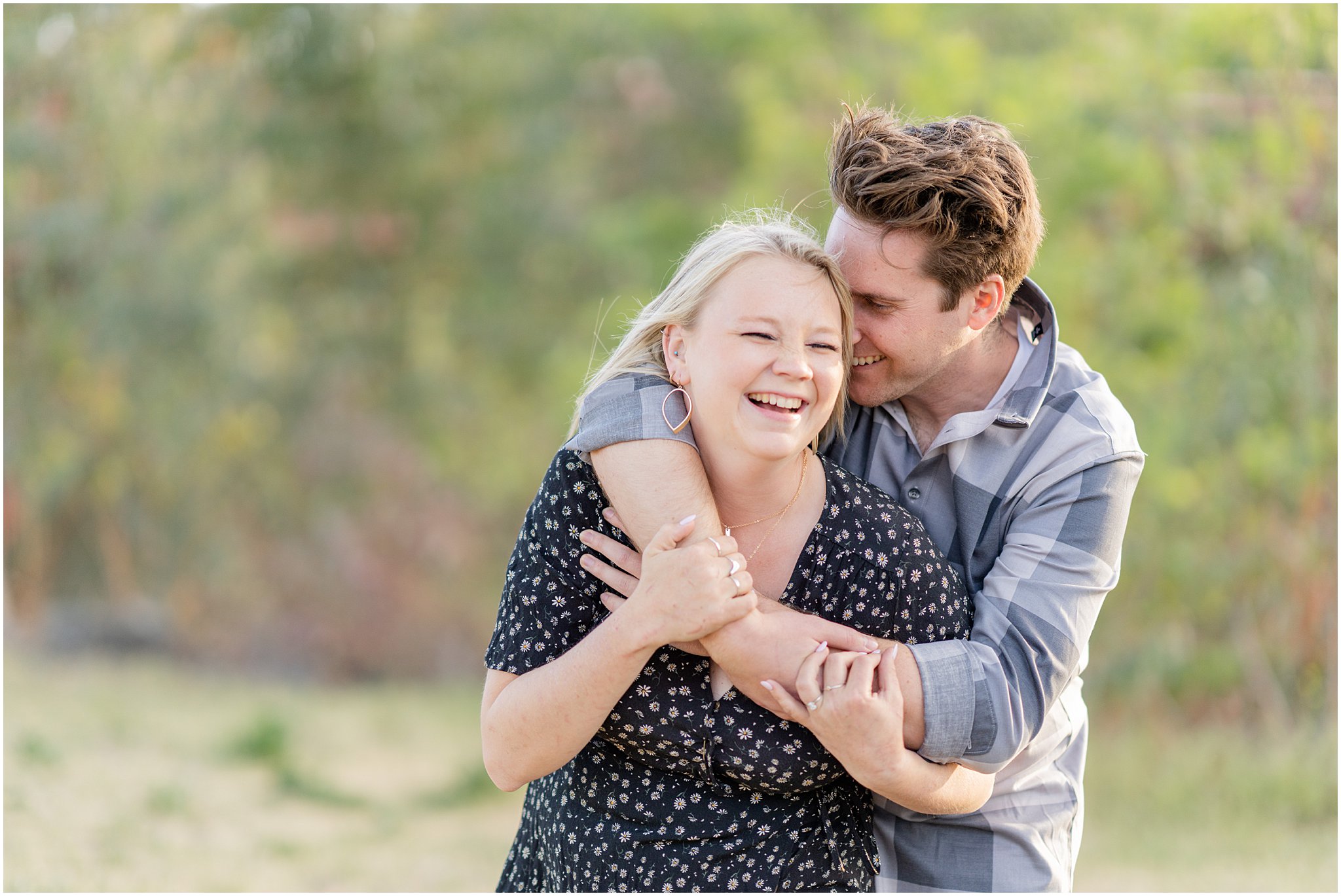 engaged couple in happy embrace laughing