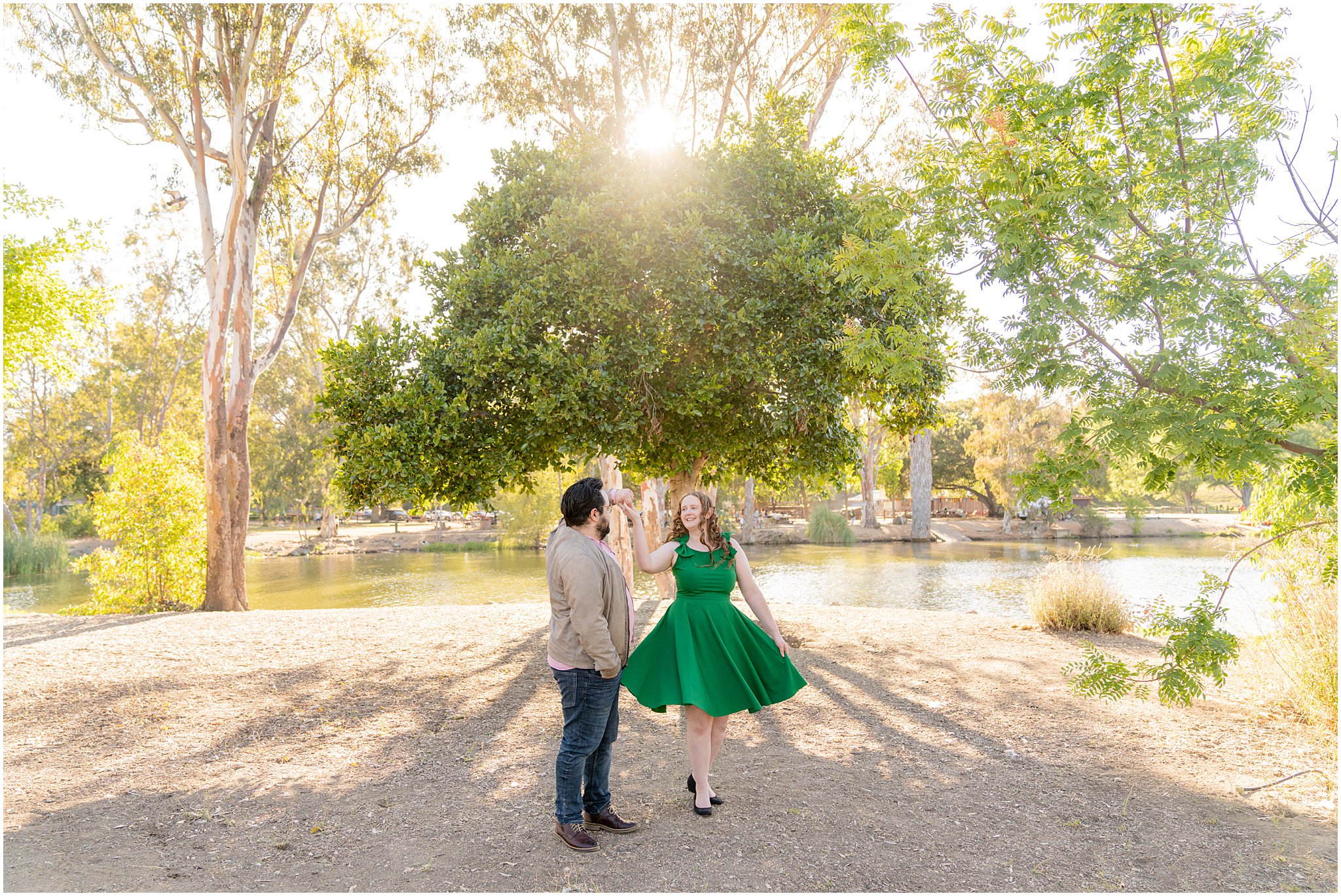 engaged couple dancing in the park