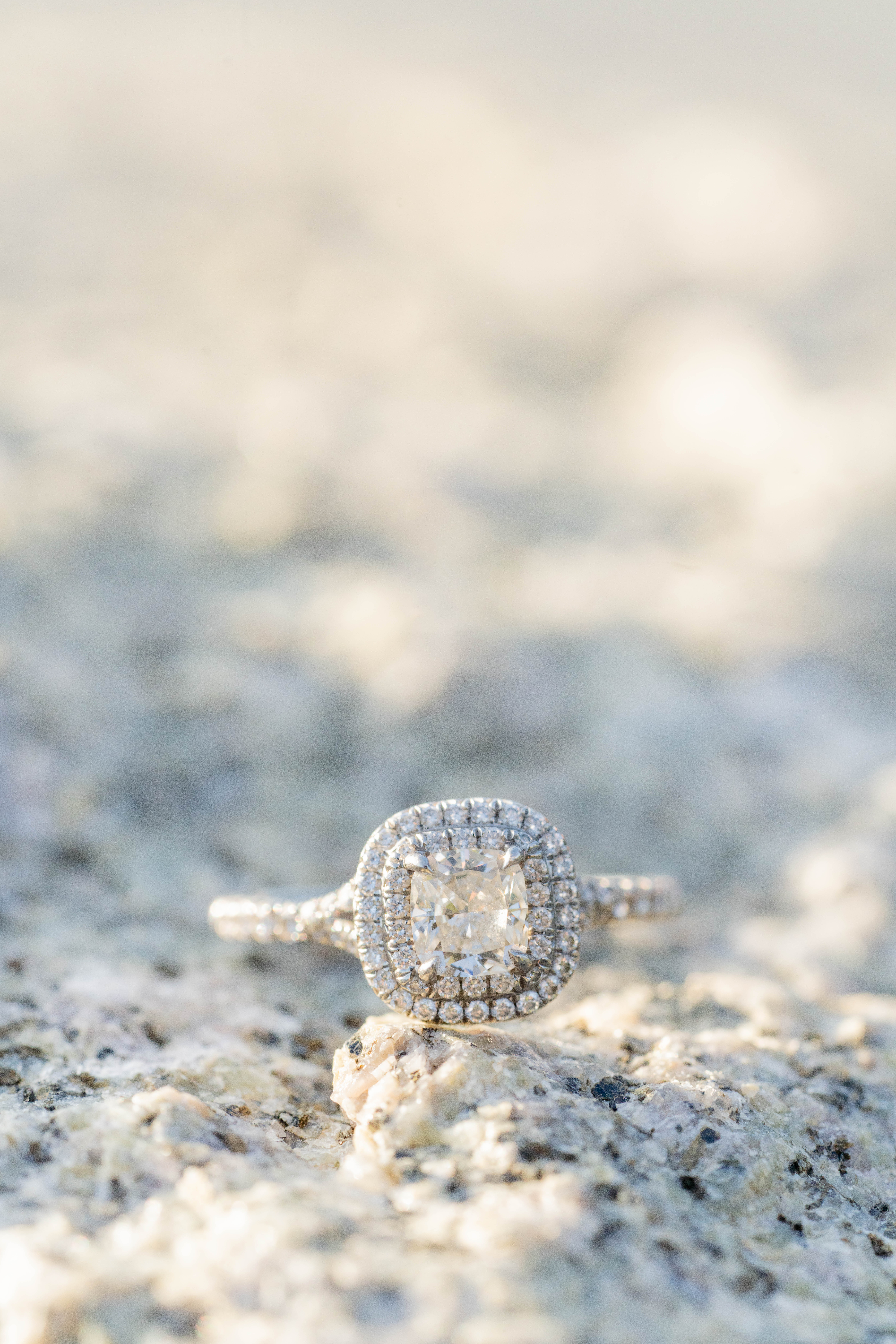 close up macro photo of diamond engagement ring with square cut and double halo